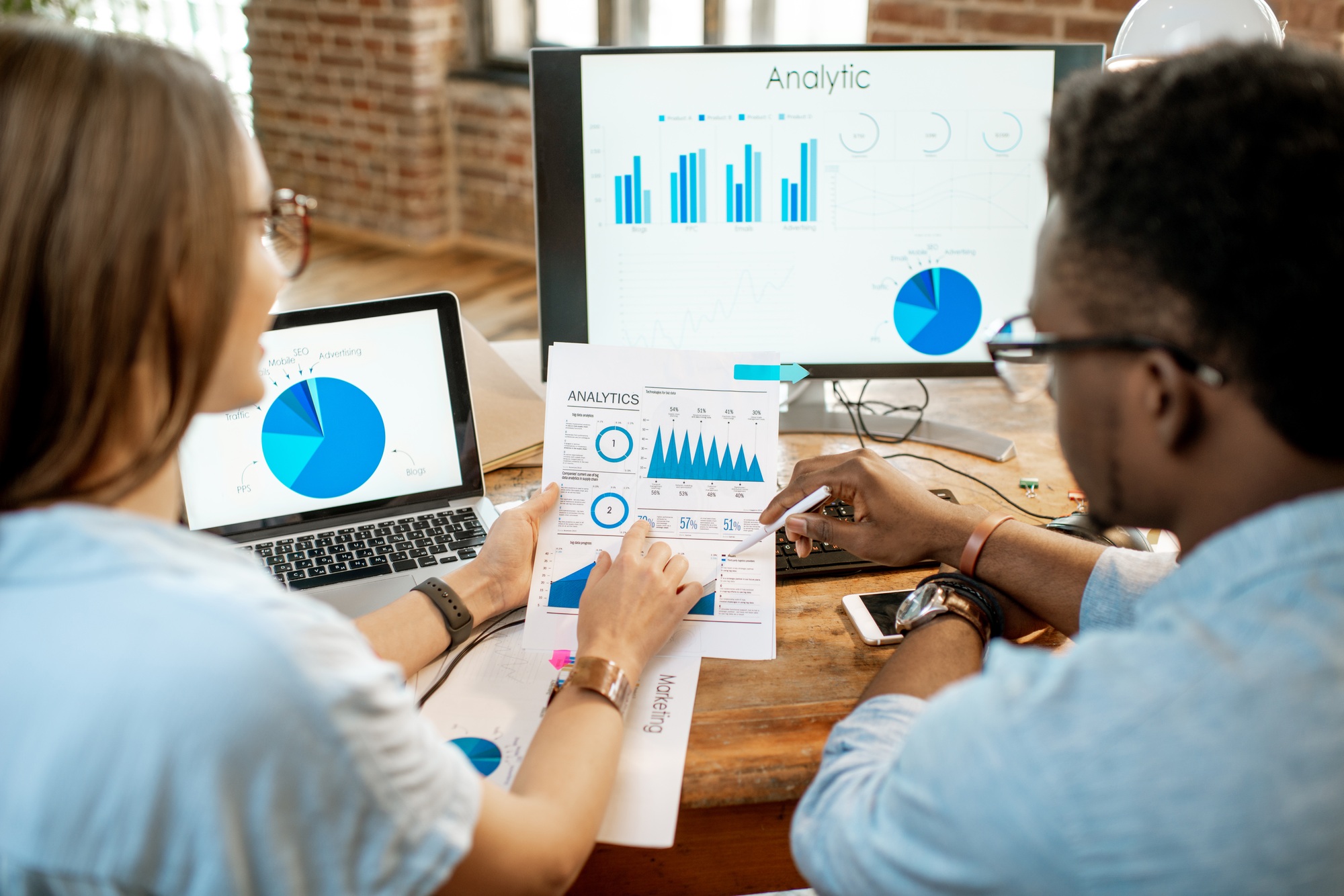 Coworkers working together with analytics